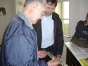 Christian shows Bill parts recovered from one of the two crash sites while touring the display Christian set up in the Church School.