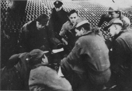 Mission briefing on the tarmac.  Earl is in the center, 2d row back.