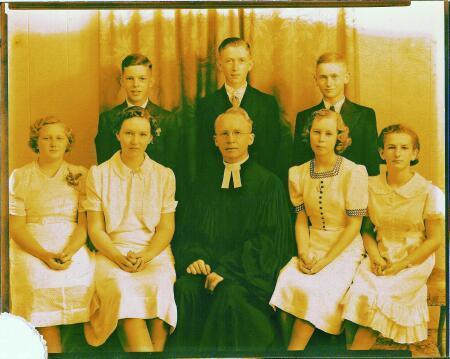 Robert standing behind his Minister